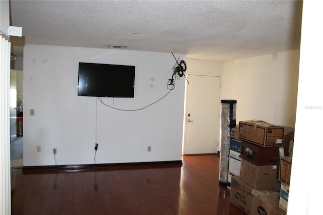 interior space with dark hardwood / wood-style flooring and a textured ceiling