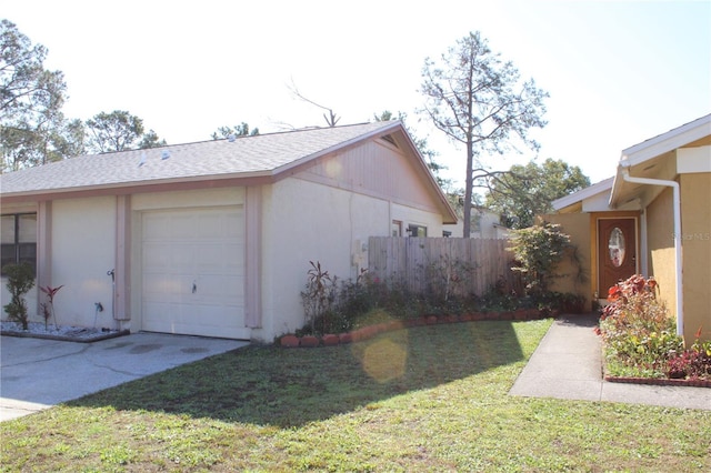 view of side of property with a garage and a yard