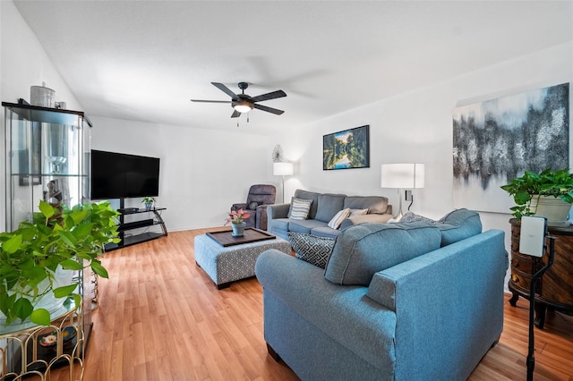 living room with wood-type flooring and ceiling fan