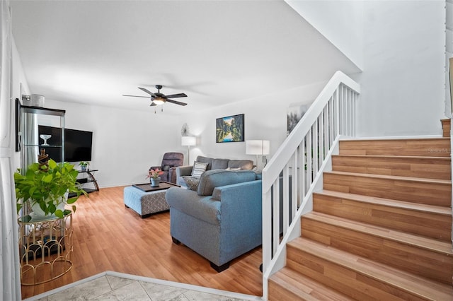 living room with wood-type flooring and ceiling fan