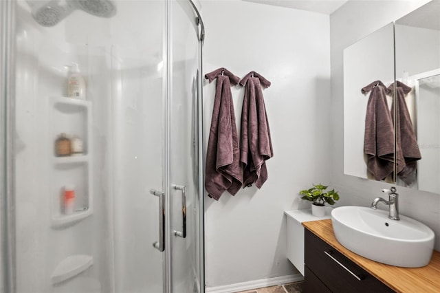 bathroom featuring walk in shower and vanity