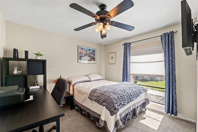 bedroom featuring ceiling fan, carpet, and a textured ceiling