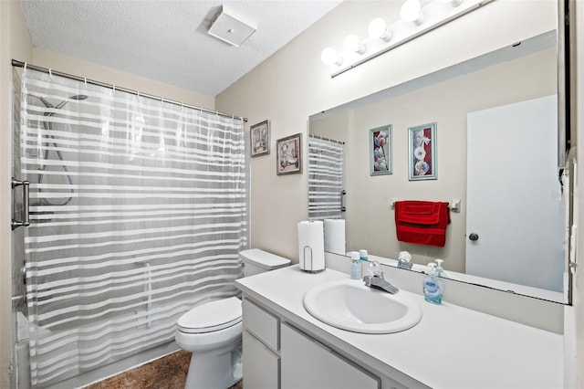 full bathroom with vanity, shower / tub combo, toilet, and a textured ceiling