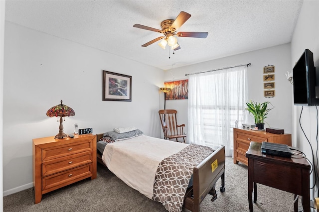 carpeted bedroom with ceiling fan and a textured ceiling