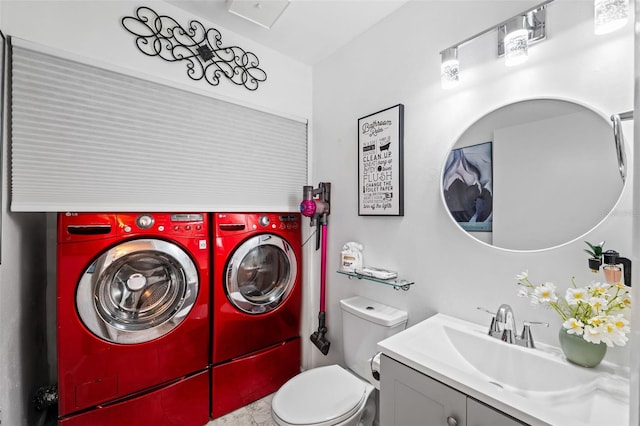 bathroom featuring separate washer and dryer, vanity, and toilet