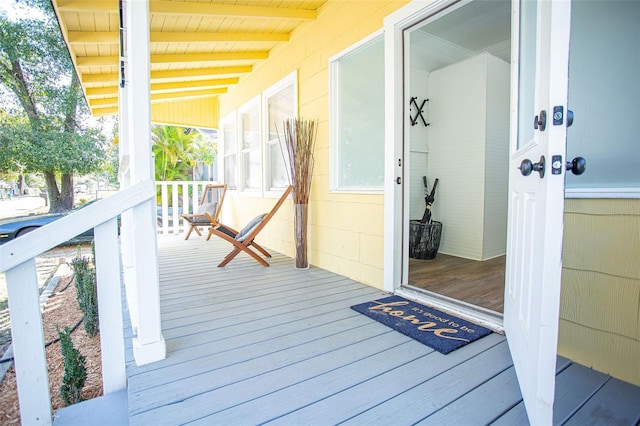 wooden terrace featuring covered porch