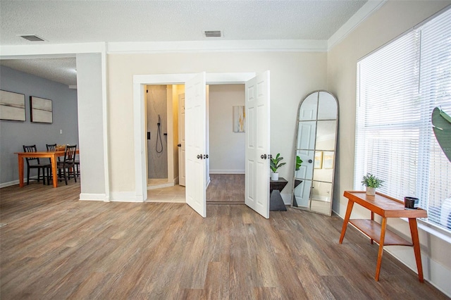 interior space with hardwood / wood-style flooring and a textured ceiling