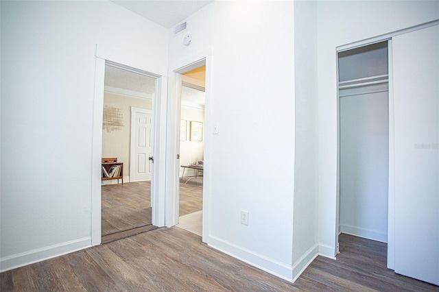 unfurnished bedroom featuring dark hardwood / wood-style flooring and a closet