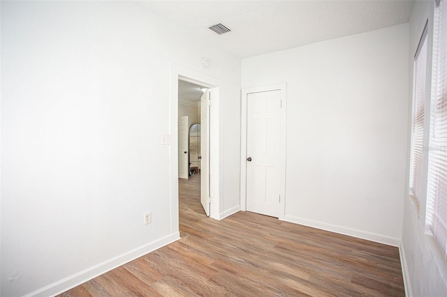 empty room featuring wood-type flooring and a textured ceiling