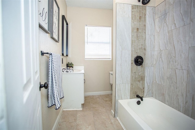 bathroom with vanity, a textured ceiling, and tiled shower / bath