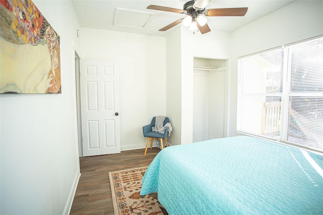 bedroom with dark wood-type flooring, a closet, and ceiling fan