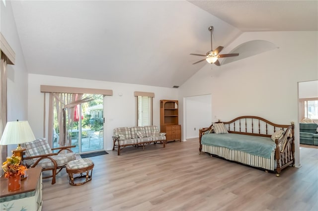 bedroom featuring access to outside, light hardwood / wood-style floors, ceiling fan, and vaulted ceiling