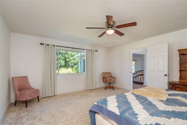 bedroom featuring ceiling fan, carpet flooring, and a textured ceiling