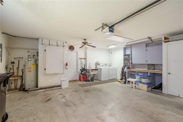 garage featuring a garage door opener, ceiling fan, electric water heater, and washer and clothes dryer