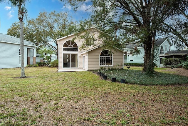 back of house with a yard