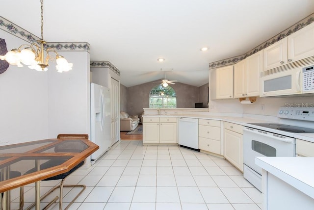 kitchen with white appliances, hanging light fixtures, light tile patterned flooring, ceiling fan with notable chandelier, and vaulted ceiling