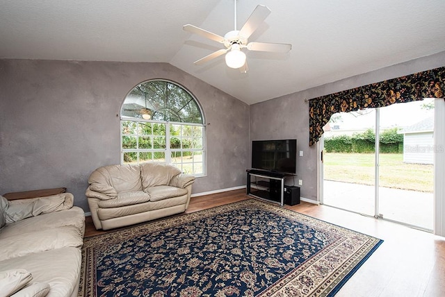 living room with lofted ceiling, wood-type flooring, and ceiling fan