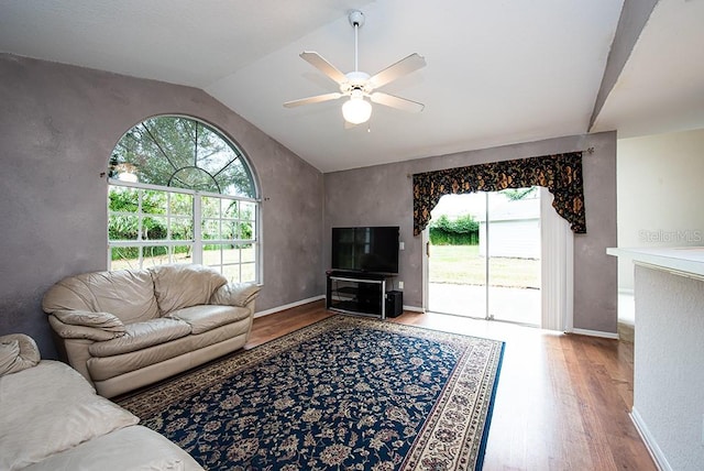 living room with hardwood / wood-style floors, vaulted ceiling, and ceiling fan