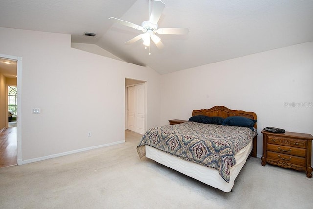 bedroom with ceiling fan, lofted ceiling, and light carpet