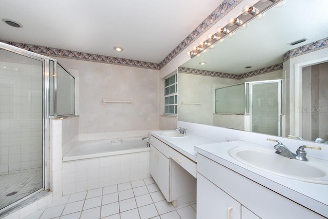 bathroom featuring tile patterned flooring, vanity, and plus walk in shower