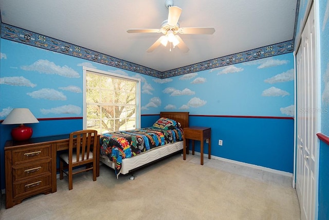 bedroom with light colored carpet, a closet, and ceiling fan