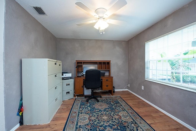 office space featuring ceiling fan and light wood-type flooring