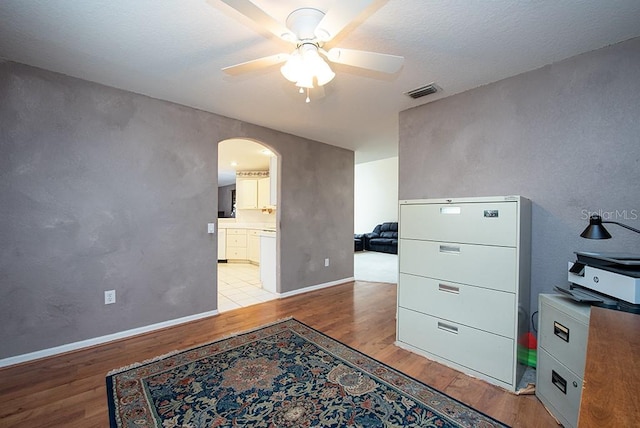 office space with ceiling fan and light hardwood / wood-style flooring