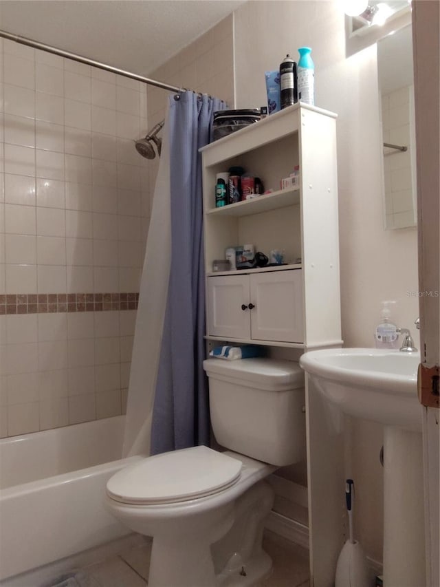 bathroom featuring shower / tub combo, tile patterned floors, and toilet