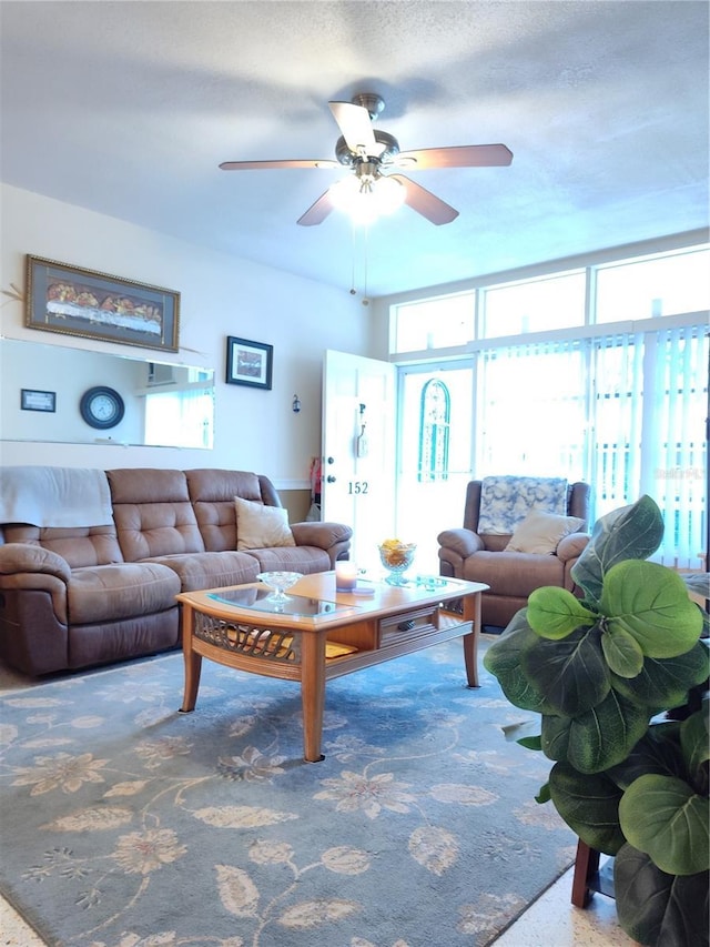 carpeted living room featuring ceiling fan