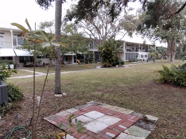 surrounding community with a lawn and a patio area