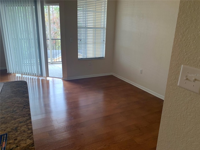 empty room featuring dark wood-type flooring