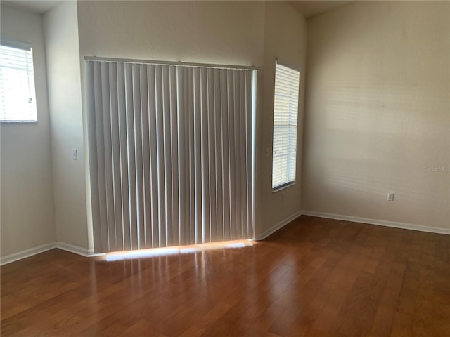 spare room featuring wood-type flooring