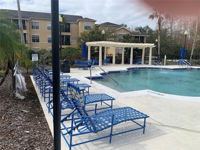 view of pool with a patio and a pergola