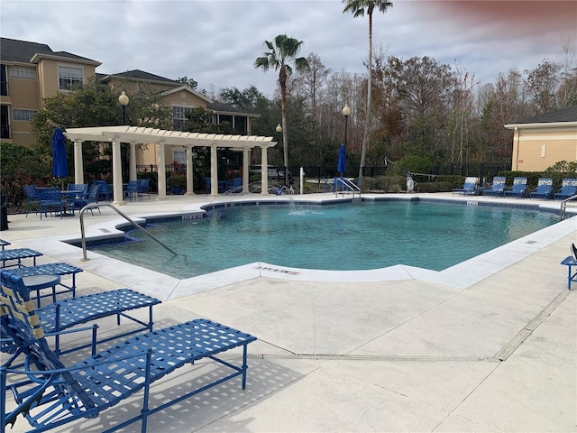 view of swimming pool with a patio and a pergola