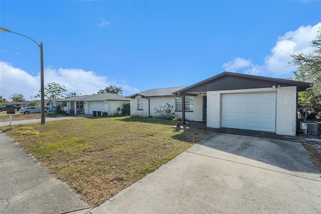 ranch-style home featuring a garage, central AC unit, and a front lawn