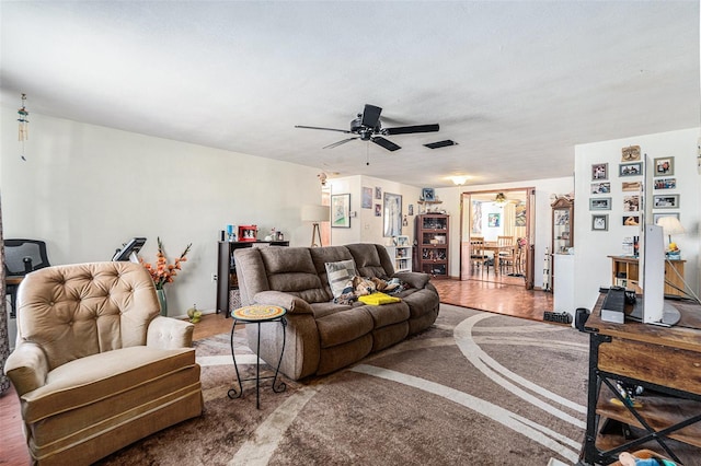 living room with ceiling fan and hardwood / wood-style floors