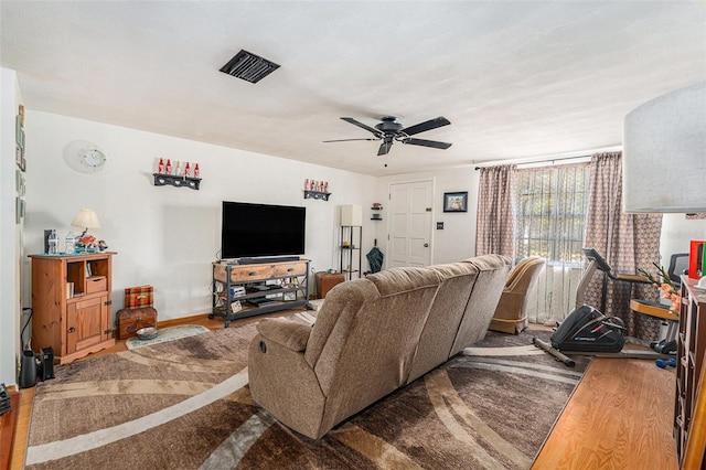 living room with wood-type flooring and ceiling fan