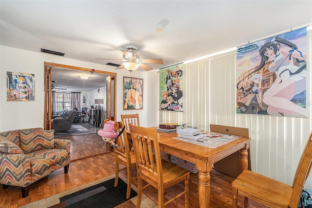 dining space with hardwood / wood-style flooring and ceiling fan