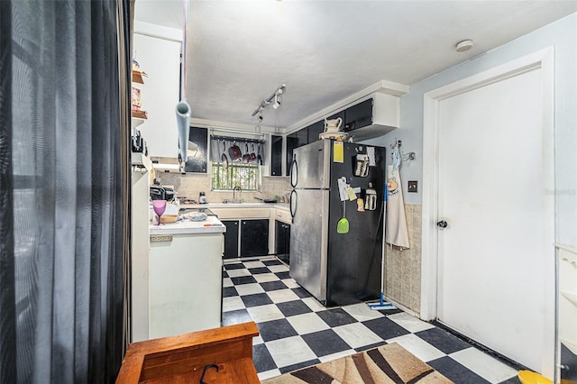 kitchen featuring stainless steel fridge and sink