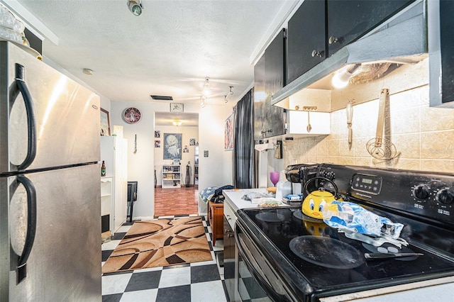 kitchen with tasteful backsplash, black electric range oven, and stainless steel fridge