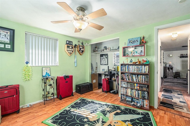 interior space with wood-type flooring and ceiling fan