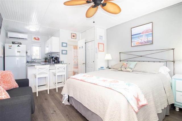 bedroom with ceiling fan, a wall unit AC, dark wood-type flooring, and white fridge