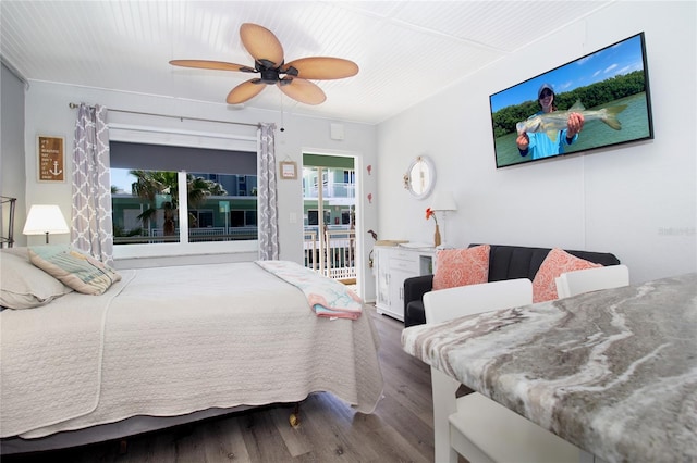 bedroom with ceiling fan, wood-type flooring, and access to outside