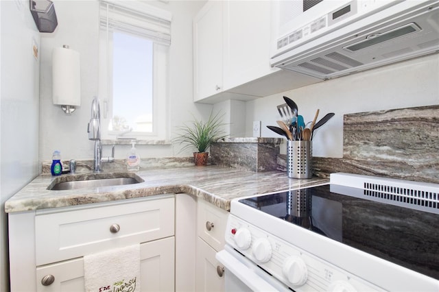 kitchen with white cabinetry, white appliances, and sink