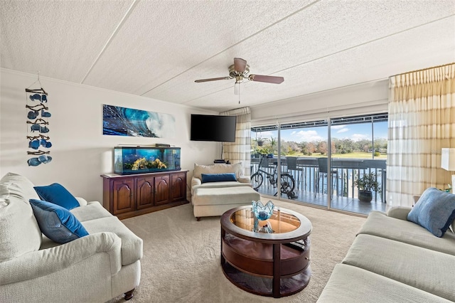 carpeted living room with crown molding, ceiling fan, and a textured ceiling