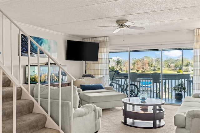 living room featuring crown molding, ceiling fan, and a textured ceiling