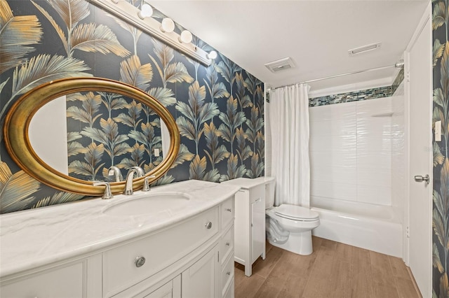 full bathroom featuring toilet, wood-type flooring, vanity, and shower / bath combo with shower curtain