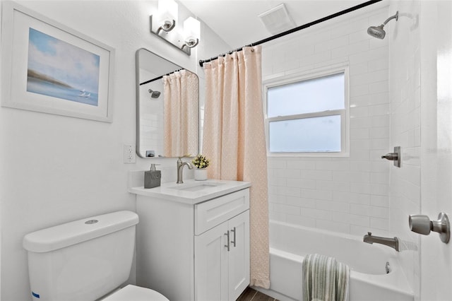 full bathroom featuring visible vents, vanity, toilet, and shower / bath combo with shower curtain