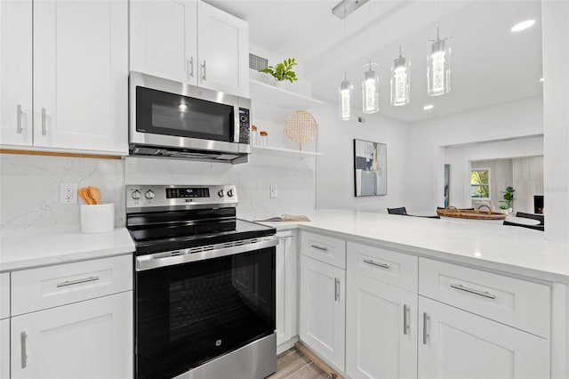 kitchen featuring appliances with stainless steel finishes, decorative backsplash, and white cabinets