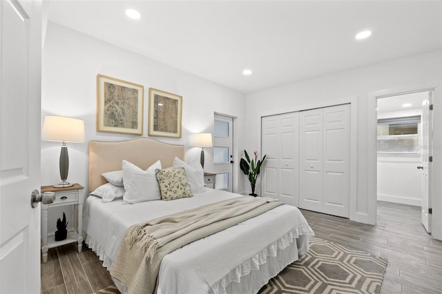 bedroom with recessed lighting, a closet, baseboards, and wood finished floors